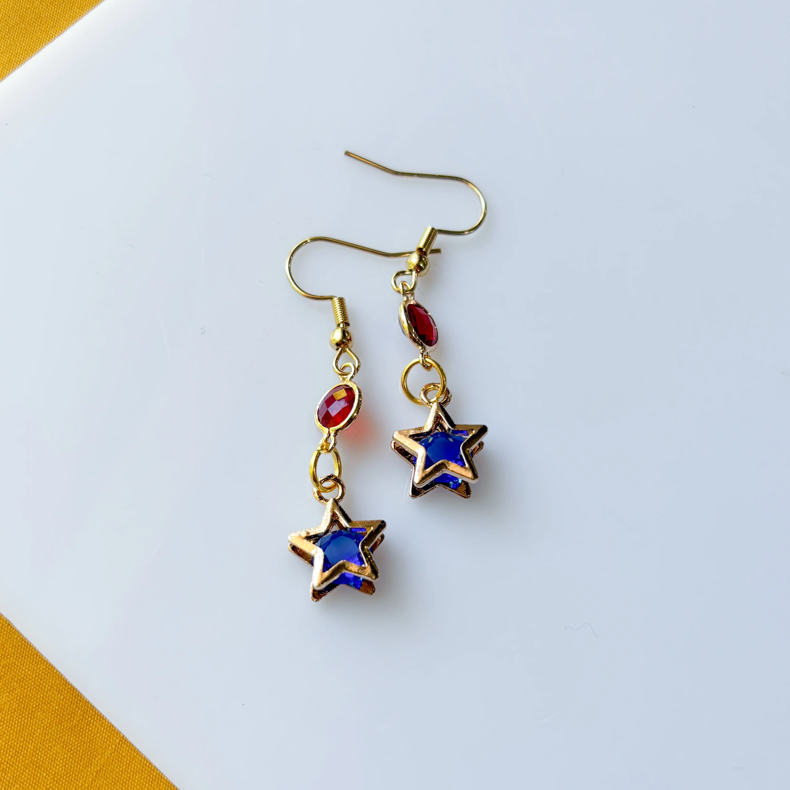 RED CIRCLE BLUE STAR CHARM EARRINGS - Image 1