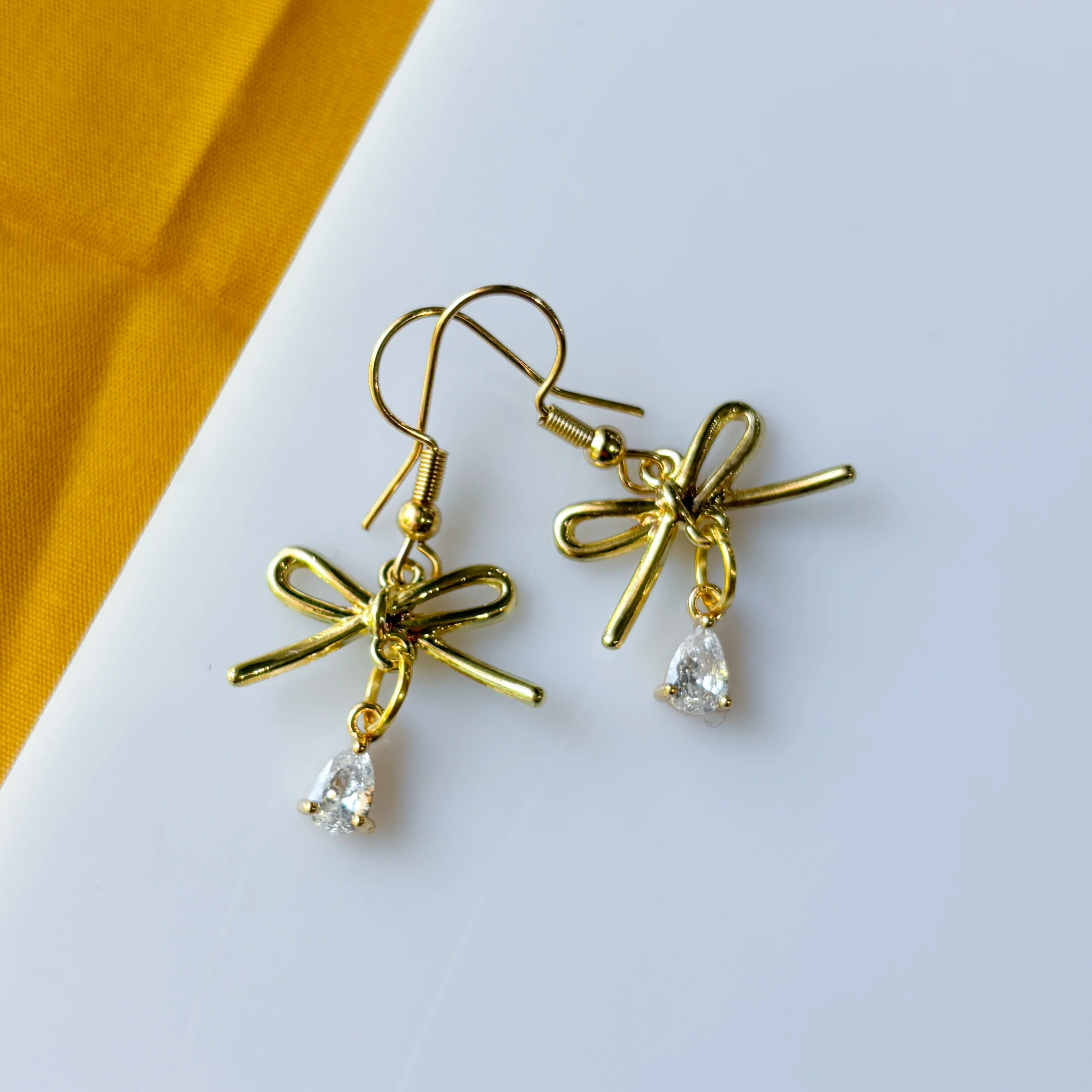 GOLD BOW & CRYSTAL TEARDROP CHARM EARRINGS - Image 2