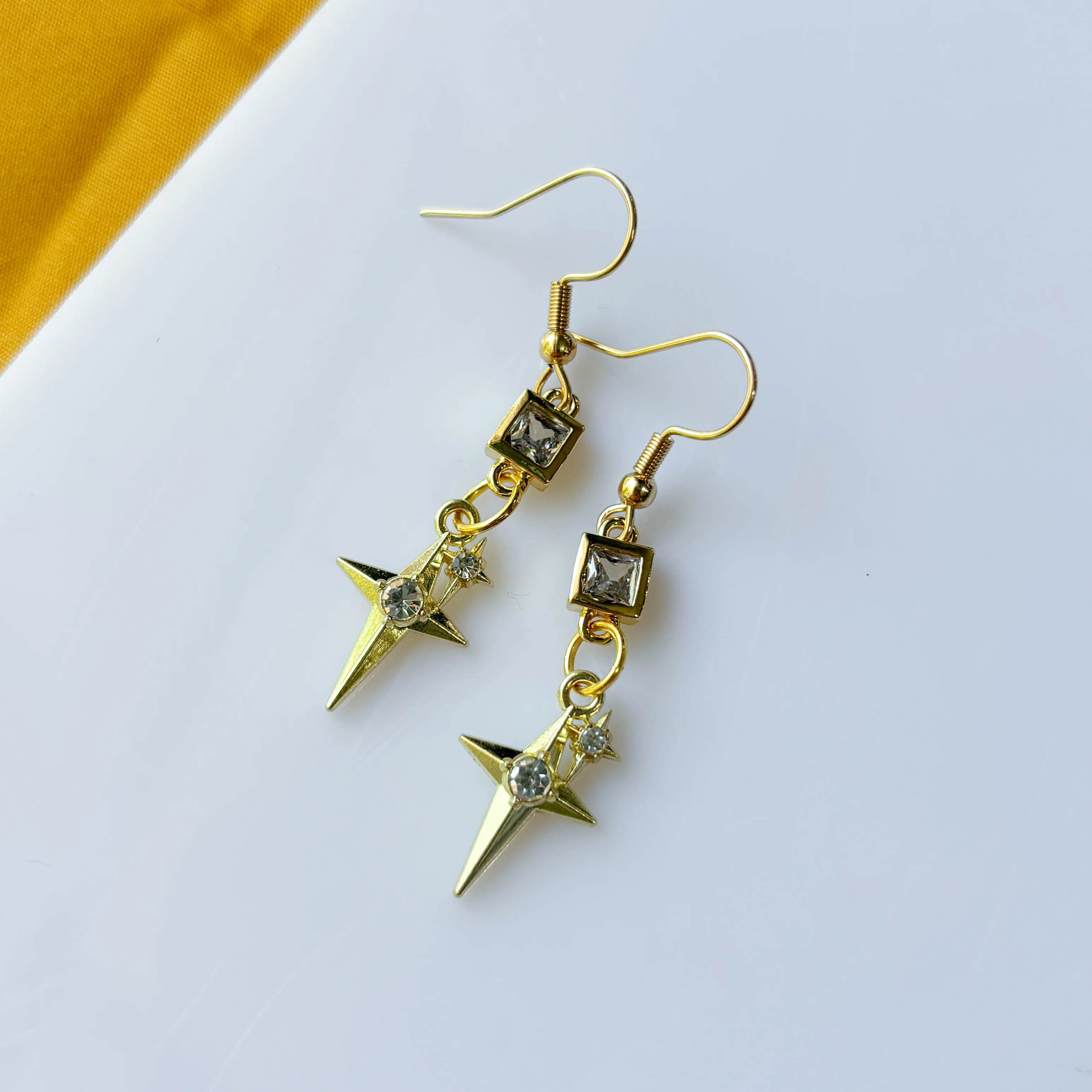 SQUARE CRYSTAL & DOUBLED STAR GOLD CHARM EARRINGS - Image 1