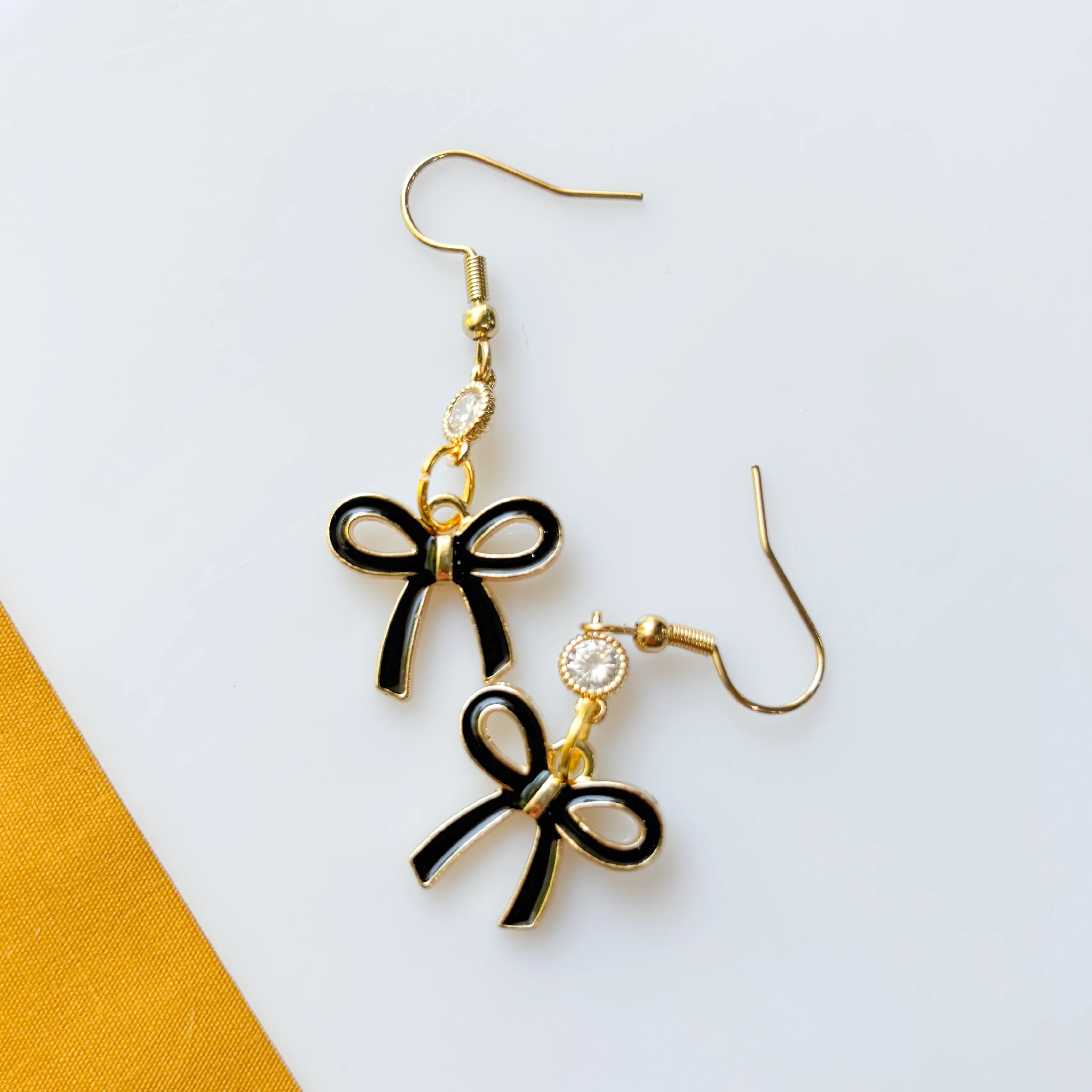 BLACK BOW CHARM EARRINGS - Image 1