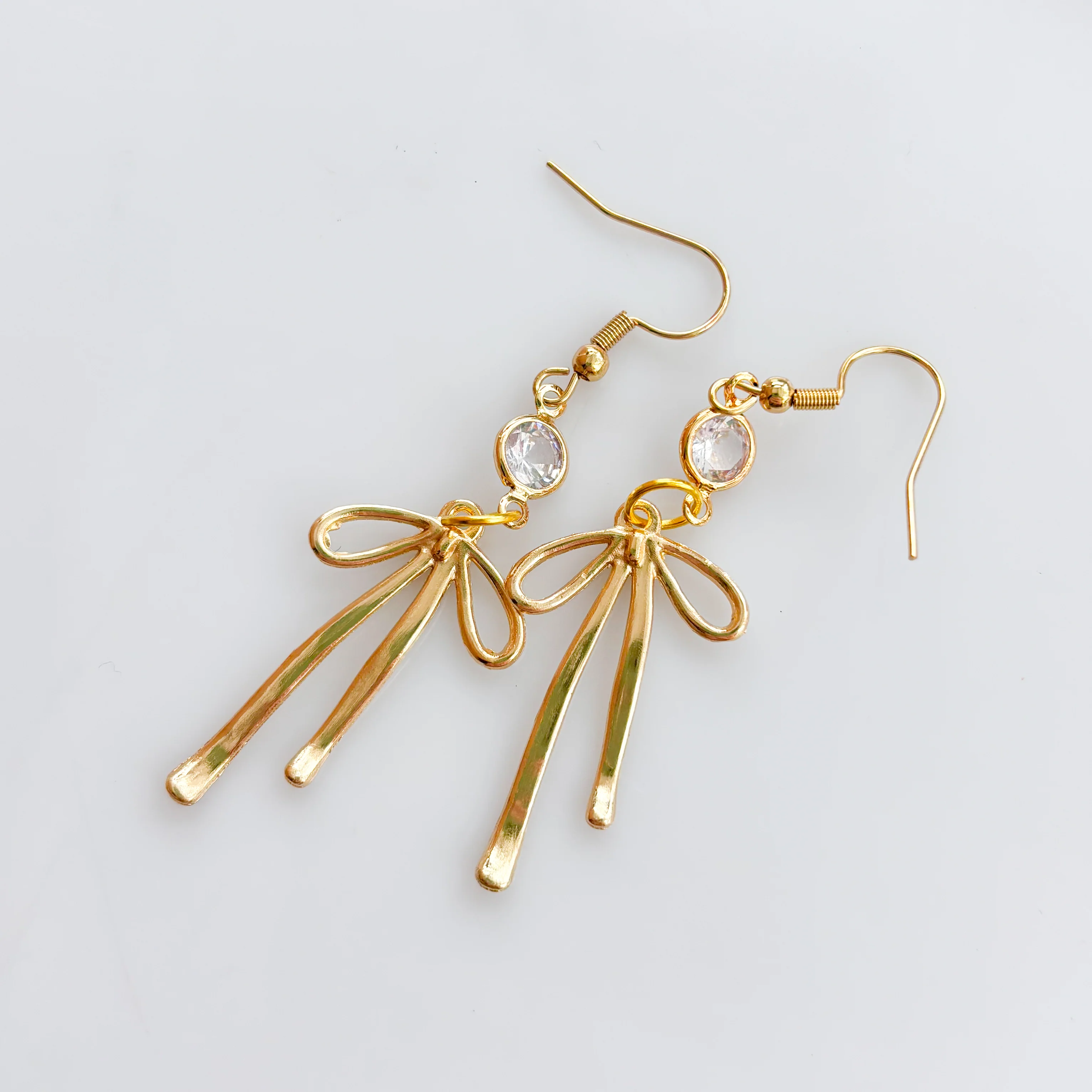 LONG GOLD BOW & GEM CHARM EARRINGS